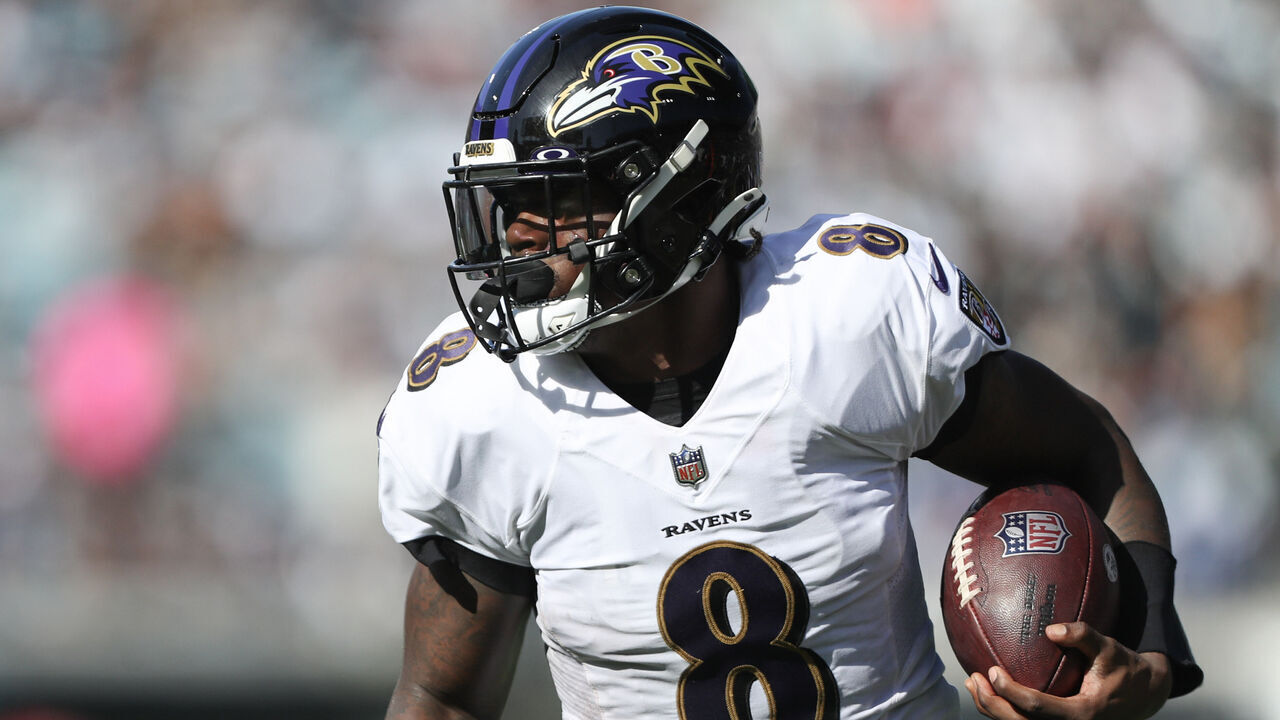 JACKSONVILLE, FLORIDA - NOVEMBER 27: Lamar Jackson #8 of the Baltimore Ravens carries the ball during the first half against the Jacksonville Jaguars at TIAA Bank Field on November 27, 2022 in Jacksonville, Florida.