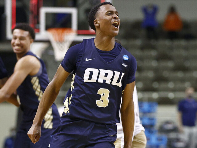 INDIANAPOLIS, INDIANA - MARCH 21: Max Abmas #3 of the Oral Roberts Golden Eagles celebrates with teammates after defeating the Florida Gators in the second round game of the 2021 NCAA Men's Basketball Tournament at Indiana Farmers Coliseum on March 21, 2021 in Indianapolis, Indiana. Oral Roberts defeated Florida 81-78.