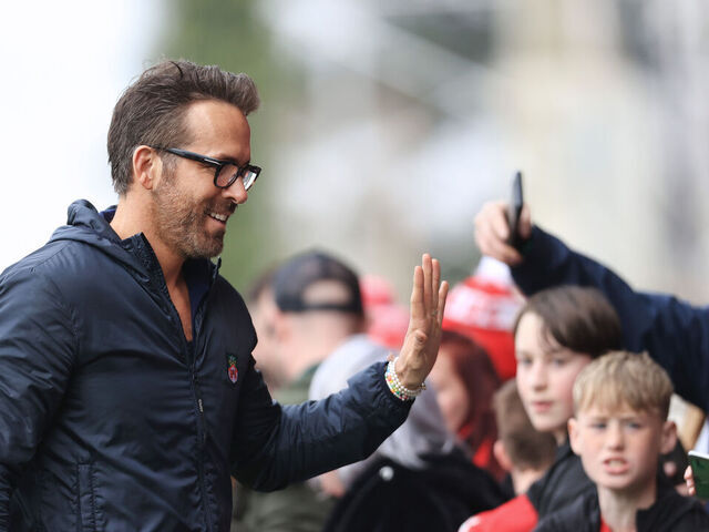 WREXHAM, WALES - APRIL 22: Wrexham co-owner Ryan Reynolds greets fans before the Vanarama National League match between Wrexham and Boreham Wood at Racecourse Ground on April 22, 2023 in Wrexham, Wales.