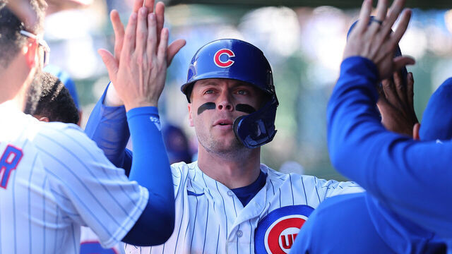 CHICAGO, ILLINOIS - APRIL 27: Nico Hoerner #2 of the Chicago Cubs high fives teammates after scoring a run during the fifth inning against the San Diego Padres at Wrigley Field on April 27, 2023 in Chicago, Illinois.