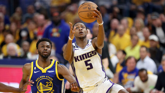SAN FRANCISCO, CALIFORNIA - APRIL 28: De'Aaron Fox #5 of the Sacramento Kings goes up for a shot on Andrew Wiggins #22 of the Golden State Warriors in the first half of Game Six of the Western Conference First Round Playoffs at Chase Center on April 28, 2023 in San Francisco, California.