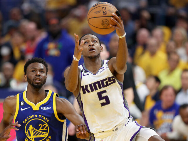 SAN FRANCISCO, CALIFORNIA - APRIL 28: De'Aaron Fox #5 of the Sacramento Kings goes up for a shot on Andrew Wiggins #22 of the Golden State Warriors in the first half of Game Six of the Western Conference First Round Playoffs at Chase Center on April 28, 2023 in San Francisco, California.
