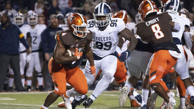 BOWLING GREEN, OH - NOVEMBER 10: Bowling Green Falcons Running Back Terion Stewart (4) runs with the ball with Toledo Rockets Defensive End Desjuan Johnson (99) in pursuit during the second half of the College Football game between the Toledo Rockets and the Bowling Green Falcons on November 10, 2021, at Doyt Perry Stadium in Bowling Green, OH.