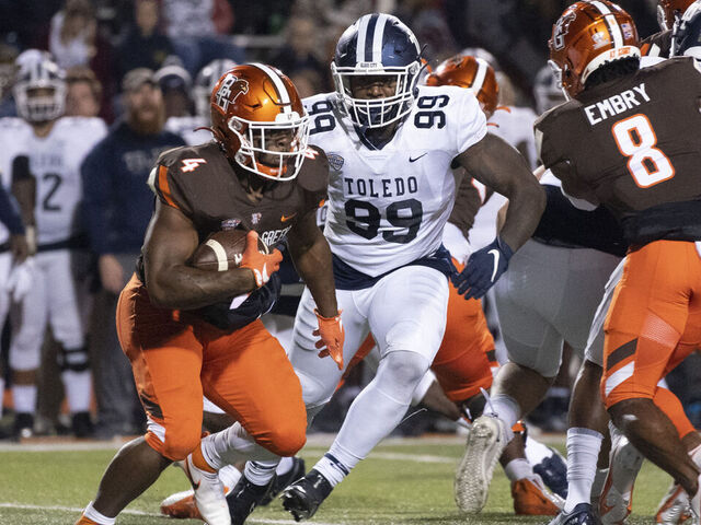 BOWLING GREEN, OH - NOVEMBER 10: Bowling Green Falcons Running Back Terion Stewart (4) runs with the ball with Toledo Rockets Defensive End Desjuan Johnson (99) in pursuit during the second half of the College Football game between the Toledo Rockets and the Bowling Green Falcons on November 10, 2021, at Doyt Perry Stadium in Bowling Green, OH.