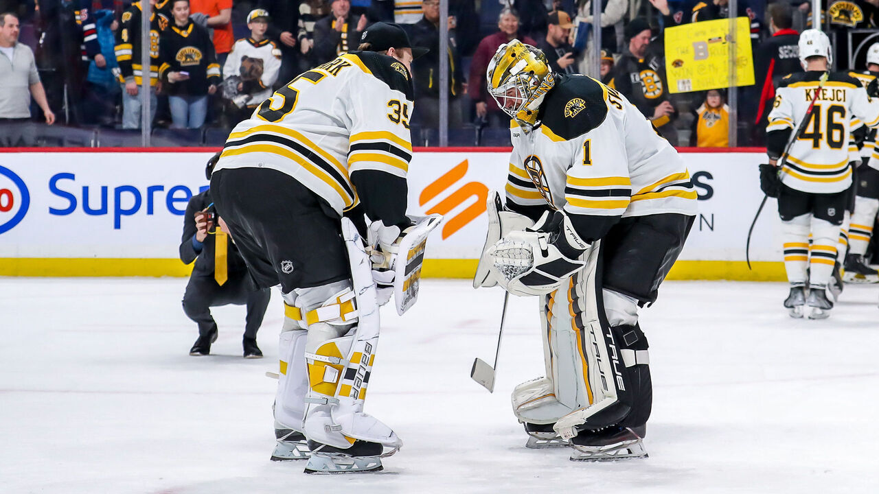 WINNIPEG, CANADA - MARCH 16: Goaltenders Linus Ullmark #35 and Jeremy Swayman #1 of the Boston Bruins celebrate following a 3-0 shutout victory over the Winnipeg Jets at the Canada Life Centre on March 16, 2023 in Winnipeg, Manitoba, Canada.