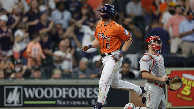 HOUSTON, TEXAS - APRIL 30: Jake Meyers #6 of the Houston Astros crosses home plate ahead of J.T. Realmuto #10 of the Philadelphia Phillies after hitting a home run during the fourth inning at Minute Maid Park on April 30, 2023 in Houston, Texas.