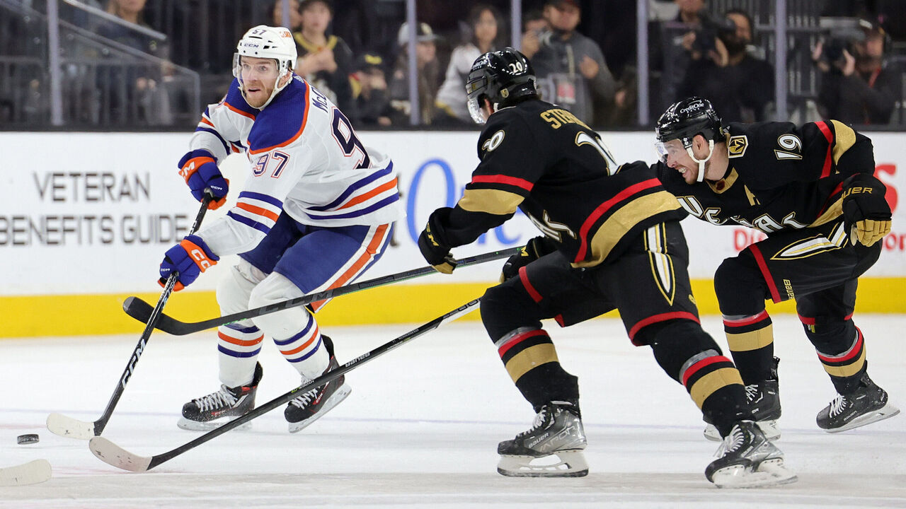 LAS VEGAS, NEVADA - JANUARY 14: Connor McDavid #97 of the Edmonton Oilers skates with the puck against Chandler Stephenson #20 and Reilly Smith #19 of the Vegas Golden Knights in the third period of their game at T-Mobile Arena on January 14, 2023 in Las Vegas, Nevada. The Oilers defeated the Golden Knights 4-3.