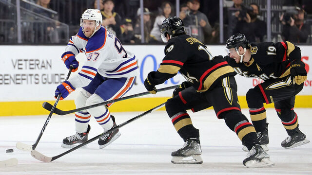 LAS VEGAS, NEVADA - JANUARY 14: Connor McDavid #97 of the Edmonton Oilers skates with the puck against Chandler Stephenson #20 and Reilly Smith #19 of the Vegas Golden Knights in the third period of their game at T-Mobile Arena on January 14, 2023 in Las Vegas, Nevada. The Oilers defeated the Golden Knights 4-3.
