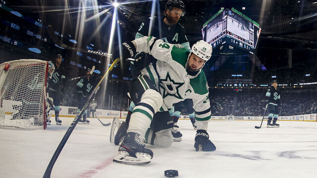 SEATTLE, WASHINGTON - MARCH 13: Jamie Benn #14 of the Dallas Stars controls the puck against Adam Larsson #6 of the Seattle Kraken during the second period at Climate Pledge Arena on March 13, 2023 in Seattle, Washington.