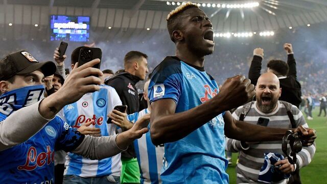 TOPSHOT - Napoli fans join Napoli's Nigerian forward Victor Osimhen (C) as he celebrates after the Italian Serie A football match between Udinese and Napoli on May 4, 2023 at the Friuli stadium in Udine. - Napoli ended a 33-year wait to win Italy's Serie A on May 4 after a 1-1 draw at Udinese secured their third league title and emulated the great teams led by Diego Maradona.