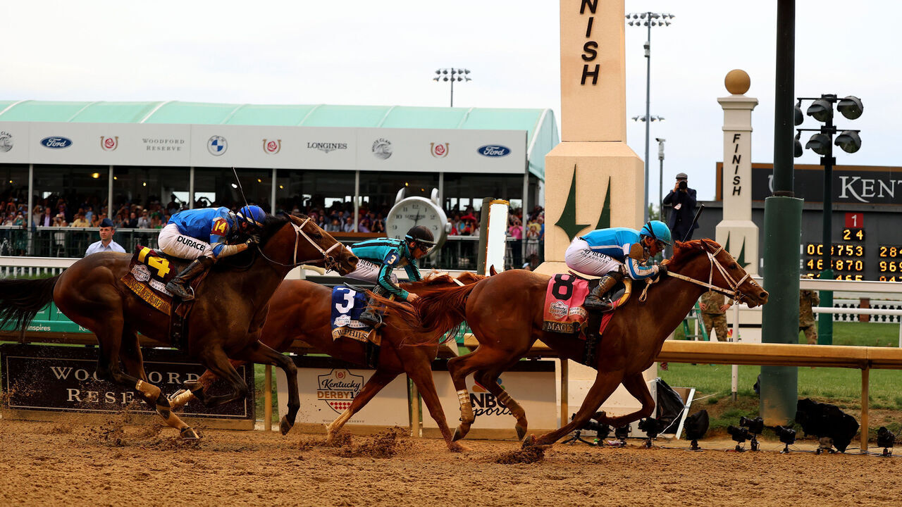 LOUISVILLE, KENTUCKY - MAY 06: Mage #8, ridden by jockey Javier Castellano crosses the finish line to win the 149th running of the Kentucky Derby at Churchill Downs on May 06, 2023 in Louisville, Kentucky.