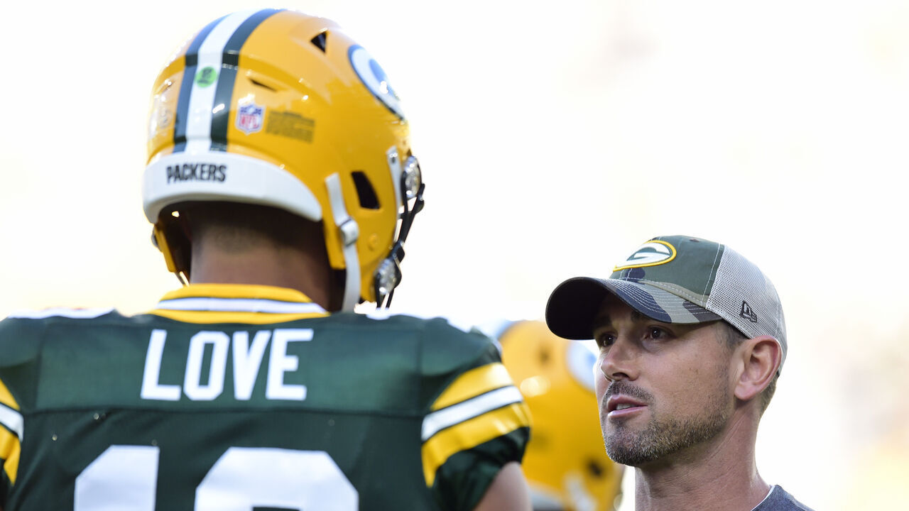 GREEN BAY, WISCONSIN - AUGUST 14: Head coach Matt LaFleur of the Green Bay Packers talks with Jordan Love #10 before the preseason game against the Houston Texans at Lambeau Field on August 14, 2021 in Green Bay, Wisconsin.