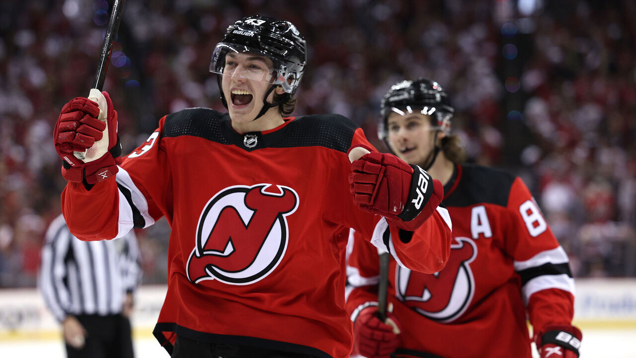 NEWARK, NEW JERSEY - MAY 07: Jack Hughes #86 and Luke Hughes #43 of the New Jersey Devils celebrate teammate Damon Severson's goal during the second period in Game Three of the Second Round of the 2023 Stanley Cup Playoffs against the Carolina Hurricanes at Prudential Center on May 07, 2023 in Newark, New Jersey. both Hughes recorded an assist on the goal.