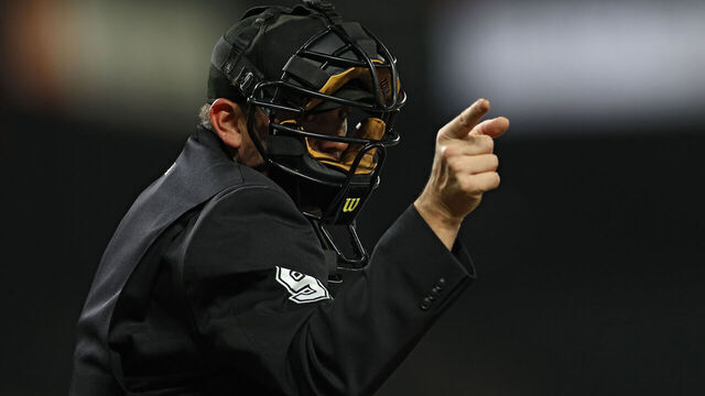BALTIMORE, MARYLAND - MAY 09: An umpire calls a strike at Oriole Park at Camden Yards on May 9, 2023 in Baltimore, Maryland.