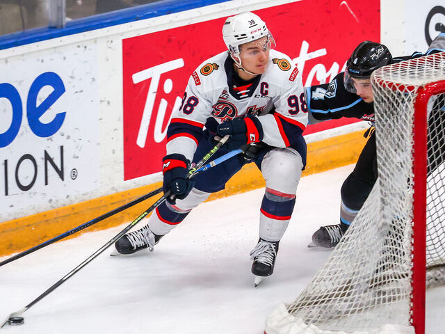 WINNIPEG, CANADA - NOVEMBER 19: Connor Bedard #98 of the Regina Pats plays the puck around the net to avoid Ben Zloty #4 of the Winnipeg ICE during third period action at Wayne Fleming Arena on November 19, 2022 in Winnipeg, Manitoba, Canada.