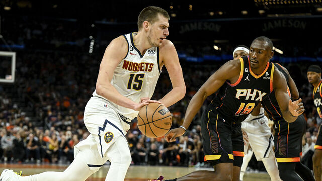 PHOENIX, AZ - MAY 11: Nikola Jokic (15) of the Denver Nuggets drives on Bismack Biyombo (18) of the Phoenix Suns during the first quarter at Footprint Center in Phoenix on Thursday, May 11, 2023.