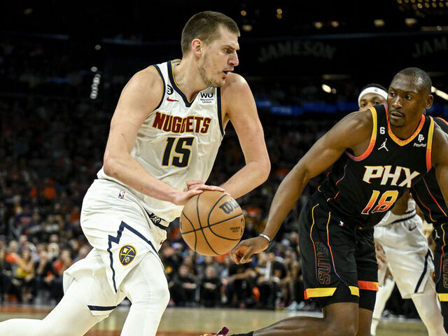 PHOENIX, AZ - MAY 11: Nikola Jokic (15) of the Denver Nuggets drives on Bismack Biyombo (18) of the Phoenix Suns during the first quarter at Footprint Center in Phoenix on Thursday, May 11, 2023.