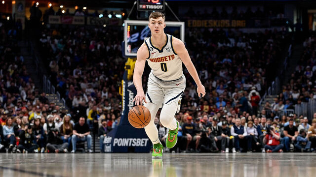 DENVER, CO - APRIL 2: Christian Braun #0 of the Denver Nuggets dribbles in the first half of a game against the Golden State Warriors at Ball Arena on April 2, 2023 in Denver, Colorado.