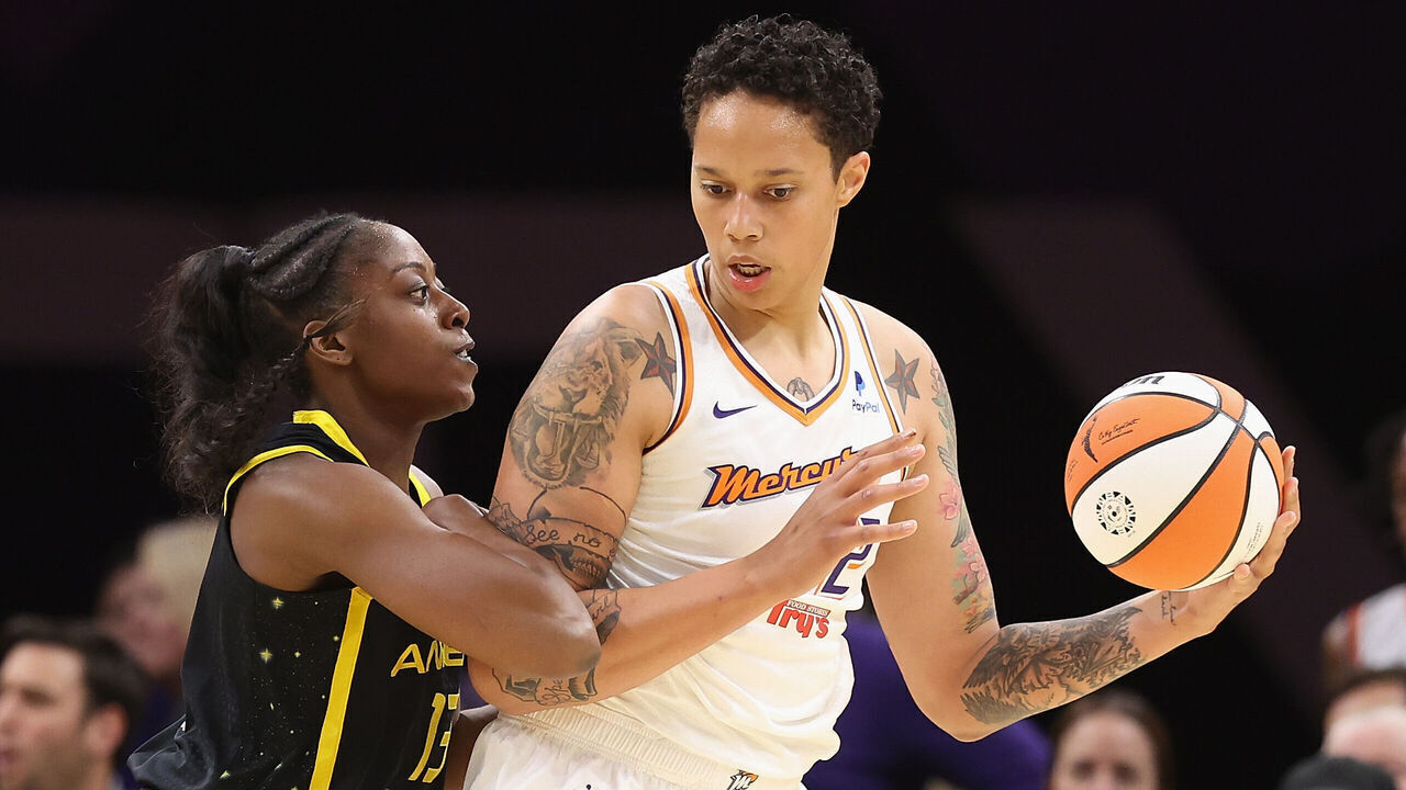 PHOENIX, ARIZONA - MAY 12: Brittney Griner #42 of the Phoenix Mercury handles the ball against Chiney Ogwumike #13 of the Los Angeles Sparks during the first half of the WNBA game at Footprint Center on May 12, 2023 in Phoenix, Arizona.