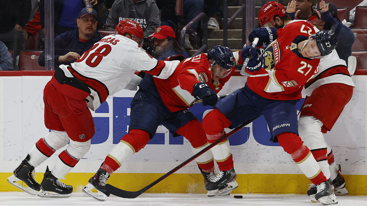 SUNRISE, FLORIDA - APRIL 13: Eetu Luostarinen #27 and teammate Anton Lundell #15 of the Florida Panthers battle for the puck against the Carolina Hurricanes at the FLA Live Arena on April 13, 2023 in Sunrise, Florida.
