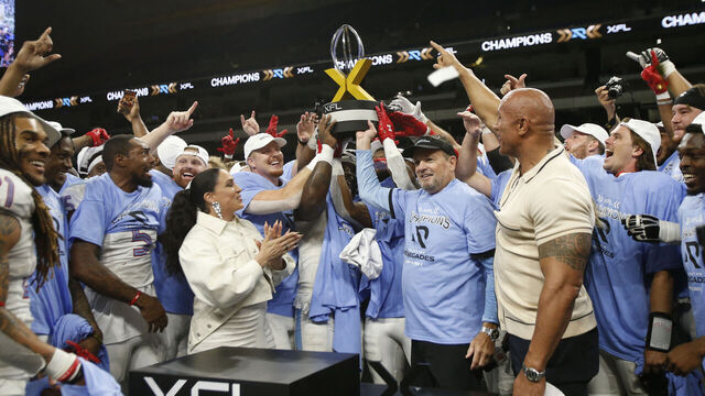 SAN ANTONIO, TX - MAY 13 : Bob Stoops head coach of the Arlington Renegades hold their trophy with teammates after they defeated DC Defenders in XFL Championship game at the Alamodome on May 13 2023 in San Antonio, Texas.