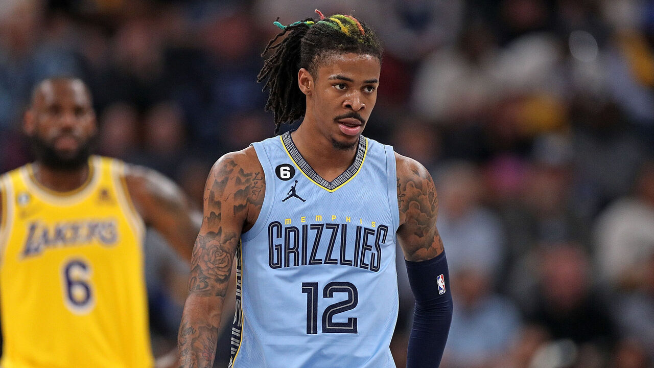 MEMPHIS, TENNESSEE - APRIL 26: Ja Morant #12 of the Memphis Grizzlies looks on as LeBron James #6 of the Los Angeles Lakers stands in the background during Game Five of the Western Conference First Round Playoffs at FedExForum on April 26, 2023 in Memphis, Tennessee.
