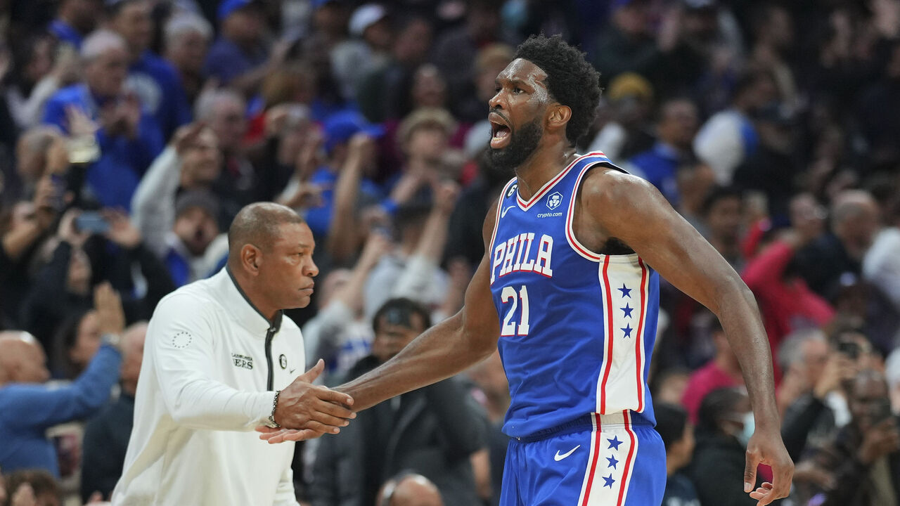 PHILADELPHIA, PA - NOVEMBER 28: Head coach Doc Rivers of the Philadelphia 76ers congratulates Joel Embiid #21 against the Atlanta Hawks at the Wells Fargo Center on November 28, 2022 in Philadelphia, Pennsylvania.