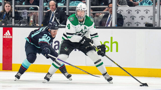 SEATTLE, WASHINGTON - MAY 12: Miro Heiskanen #4 of the Dallas Stars skates with the puck as Eeli Tolvanen #20 of the Seattle Kraken defends during the second period in Game Six of the Second Round of the 2023 Stanley Cup Playoffs at Climate Pledge Arena on May 12, 2023 in Seattle, Washington.