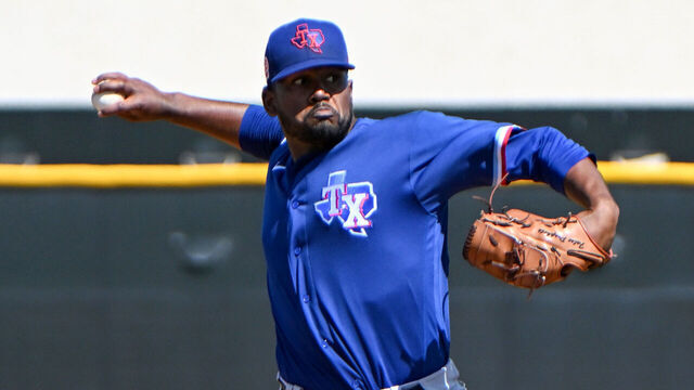 SURPRISE, ARIZONA - MARCH 25, 2023: Kumar Rocker #80 of the Texas Rangers throws a pitch during a minor league spring training game against the Kansas City Royals at Surprise Stadium on March 25, 2023 in Surprise, Arizona.