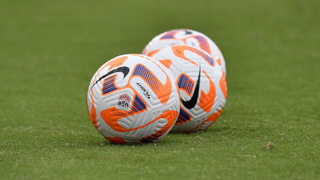 WASHINGTON, DC - SEPTEMBER 06: A close up view of Nike Flight soccer balls on a natural grass field during the Nigeria versus United States Womens National Team (USWNT USA) game on September 06, 2022, at Audi Field in Washington, D.C..
