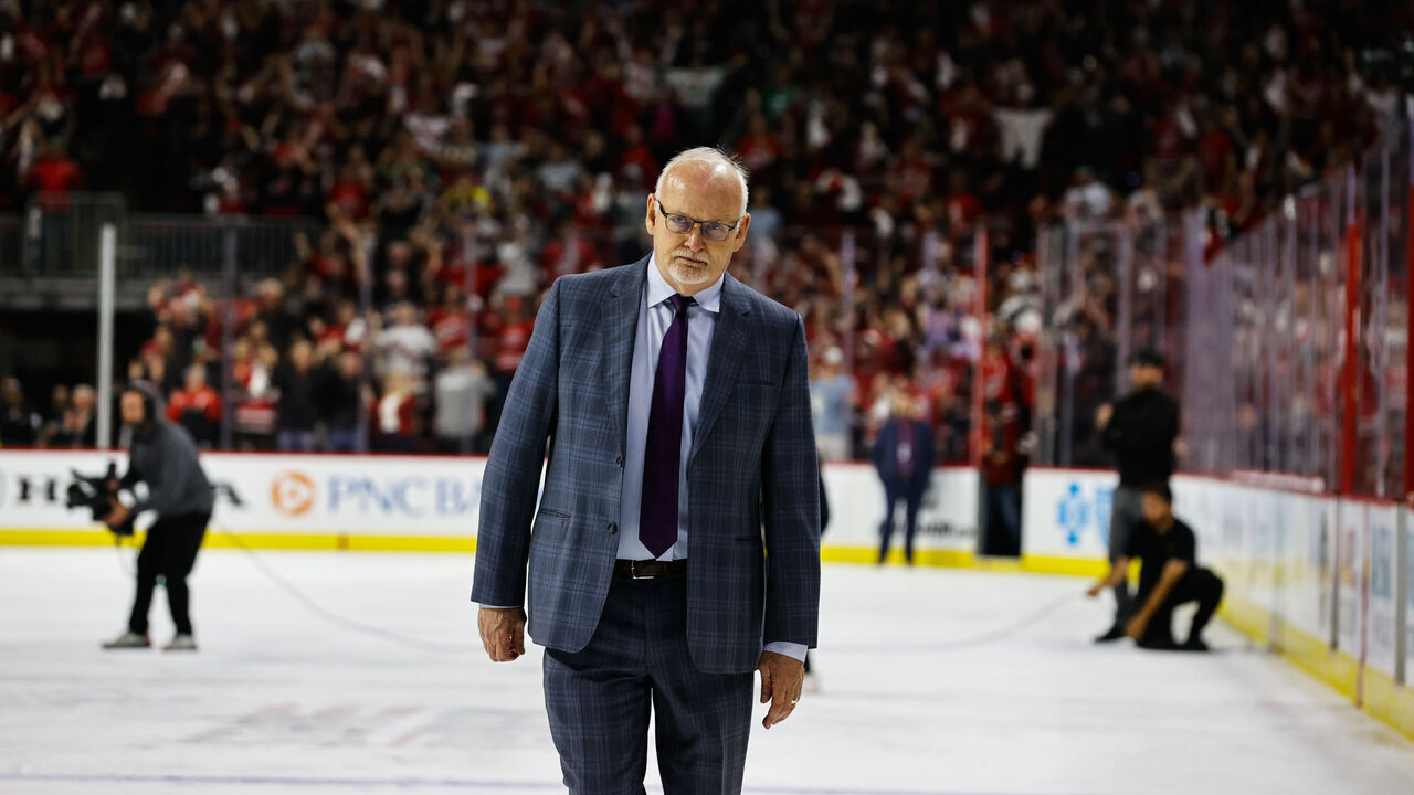 RALEIGH, NC - MAY 11: Carolina Hurricanes celebrate with their teammates while New Jersey Devils head coach Lindy Ruff exits the ice during the overtime of Eastern Conference Game Five of the Second Round of the 2023 Stanley Cup Playoffs at PNC Arena on May 11, 2023 in Raleigh, North Carolina. Hurricanes defeat Devils 3-2.
