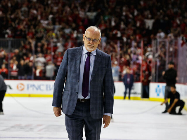 RALEIGH, NC - MAY 11: Carolina Hurricanes celebrate with their teammates while New Jersey Devils head coach Lindy Ruff exits the ice during the overtime of Eastern Conference Game Five of the Second Round of the 2023 Stanley Cup Playoffs at PNC Arena on May 11, 2023 in Raleigh, North Carolina. Hurricanes defeat Devils 3-2.