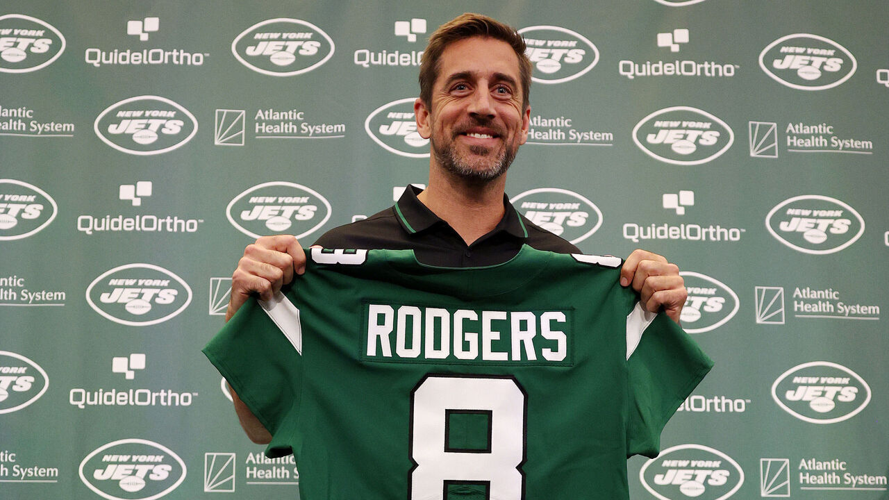 FLORHAM PARK, NEW JERSEY - APRIL 26: New York Jets quarterback Aaron Rodgers poses with a jersey during an introductory press conference at Atlantic Health Jets Training Center on April 26, 2023 in Florham Park, New Jersey.