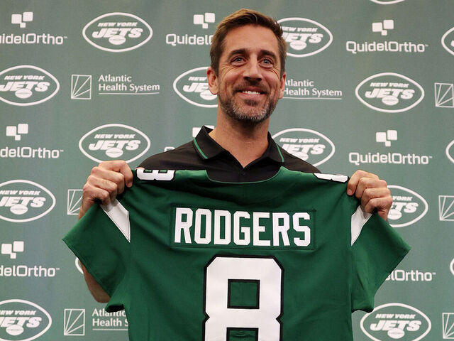 FLORHAM PARK, NEW JERSEY - APRIL 26: New York Jets quarterback Aaron Rodgers poses with a jersey during an introductory press conference at Atlantic Health Jets Training Center on April 26, 2023 in Florham Park, New Jersey.