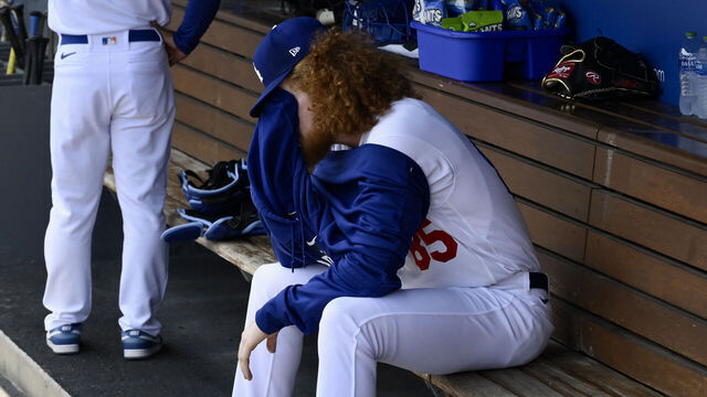 Los Angeles, - May 17: Starting pitcher Dustin May #85 of the Los Angeles Dodger wipes his face as manager Dave Robert's #30 is on the phone as May would only pitch one inning Minnesota Twins in the first inning of a baseball game at Dodger Stadium in Los Angeles on Wednesday, May 17, 2023. May left the game with elbow soreness.