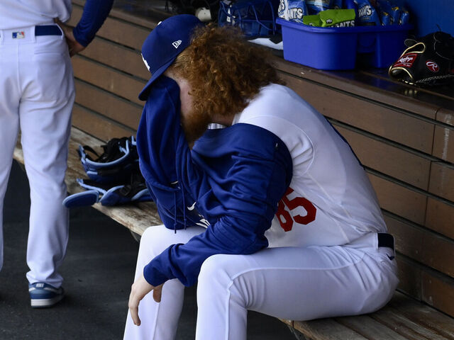 Los Angeles, - May 17: Starting pitcher Dustin May #85 of the Los Angeles Dodger wipes his face as manager Dave Robert's #30 is on the phone as May would only pitch one inning Minnesota Twins in the first inning of a baseball game at Dodger Stadium in Los Angeles on Wednesday, May 17, 2023. May left the game with elbow soreness.