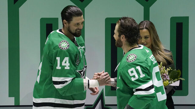DALLAS, TEXAS - MARCH 04: Jamie Benn #14 of the Dallas Stars is greeted by Tyler Seguin #91 during a ceremony commemorating Benn's 1,000th NHL game before the game against the Colorado Avalanche at American Airlines Center on March 04, 2023 in Dallas, Texas.