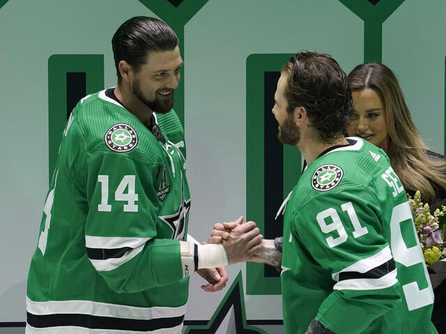 DALLAS, TEXAS - MARCH 04: Jamie Benn #14 of the Dallas Stars is greeted by Tyler Seguin #91 during a ceremony commemorating Benn's 1,000th NHL game before the game against the Colorado Avalanche at American Airlines Center on March 04, 2023 in Dallas, Texas.