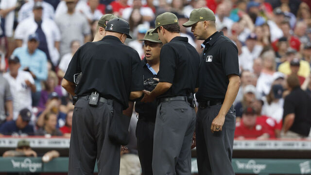 CINCINNATI, OH - MAY 19: The Umpiring Crew huddle up during the game between the New York Yankees and the Cincinnati Reds at Great American Ball Park on Friday, May 19, 2023 in Cincinnati, Ohio.