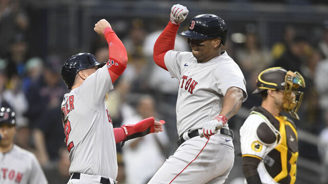 SAN DIEGO, CA - MAY 19: Rafael Devers #11 (R) of the Boston Red Sox is congratulated by Justin Turner #2 after hitting a three-run home run during the third inning of a baseball game against the San Diego Padres at Petco Park on May 19, 2023 in San Diego, California.