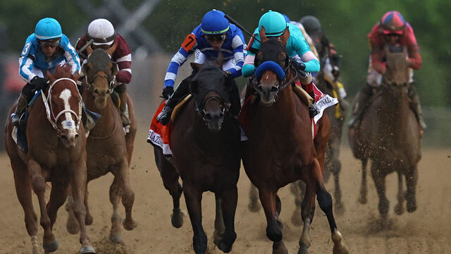 BALTIMORE, MARYLAND - MAY 20: Jockey John Velazquez #1 riding National Treasure (R) rides alongside jockey Irad Ortiz Jr. #7 riding Blazing Sevens (L) to cross the finish line first to win the 148th Running of the Preakness Stakes at Pimlico Race Course on May 20, 2023 in Baltimore, Maryland.
