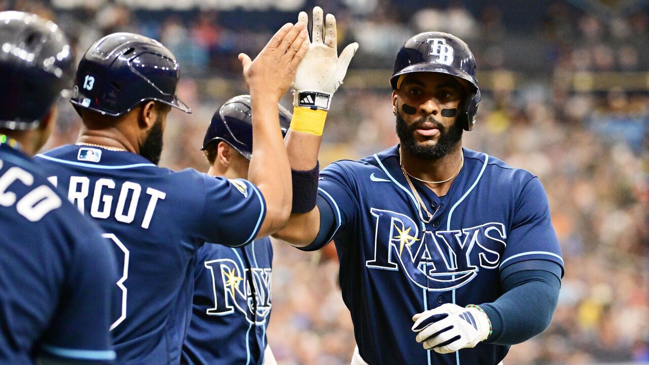 ST PETERSBURG, FLORIDA - MAY 20: Yandy Diaz #2 of the Tampa Bay Rays celebrates with Manuel Margot #13 after hitting a 3-run home run in the second inning against the Milwaukee Brewers at Tropicana Field on May 20, 2023 in St Petersburg, Florida.