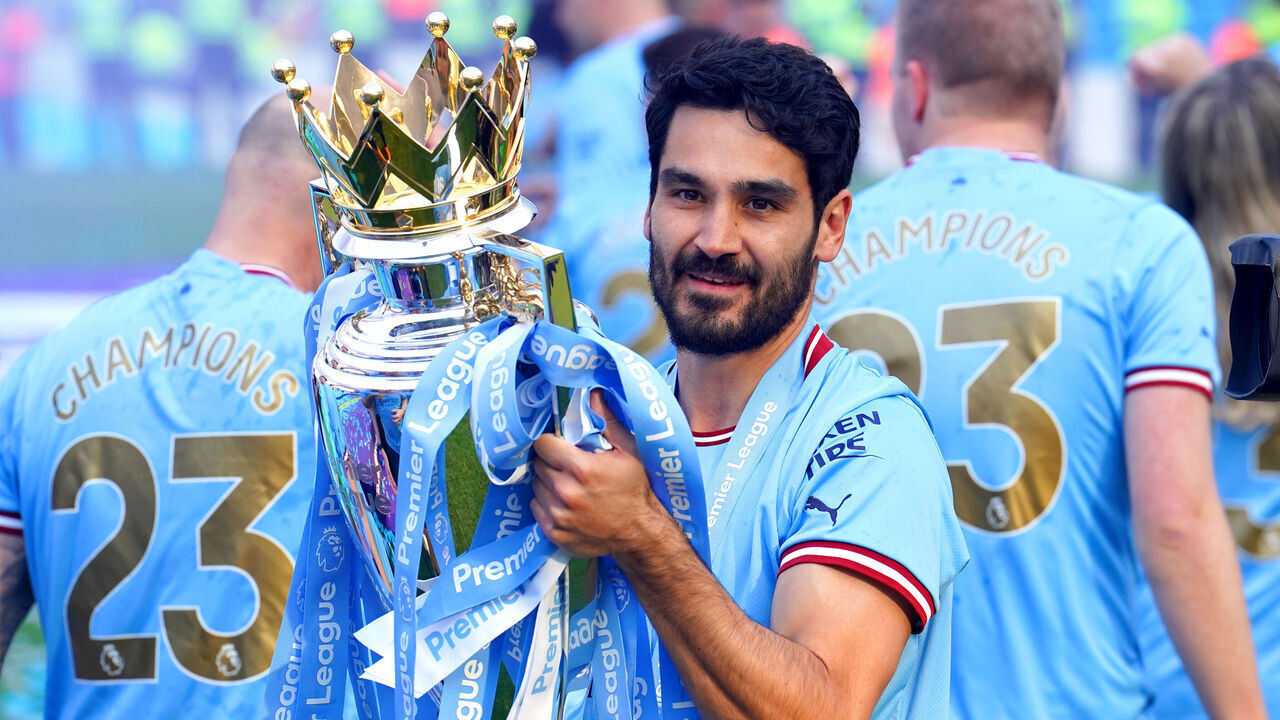 Manchester City's Ilkay Gundogan celebrates with the Premier League trophy following the Premier League match at the Etihad Stadium, Manchester. Picture date: Sunday May 21, 2023.