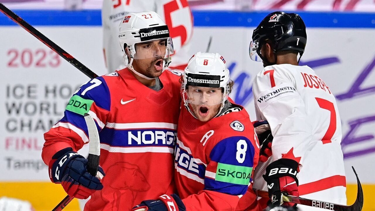 Norway's forward Andreas Martinsen (C-L) celebrates with Norway's forward Mathias Trettenes after he scored during the IIHF Ice Hockey Men's World Championships Preliminary Round - Group B match between Canada and Norway in Riga, Latvia, on May 22, 2023.