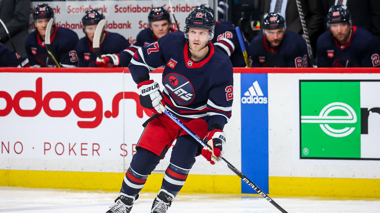 WINNIPEG, CANADA - APRIL 2: Nikolaj Ehlers #27 of the Winnipeg Jets plays the puck during second period action against the New Jersey Devils at the Canada Life Centre on April 2, 2023 in Winnipeg, Manitoba, Canada.