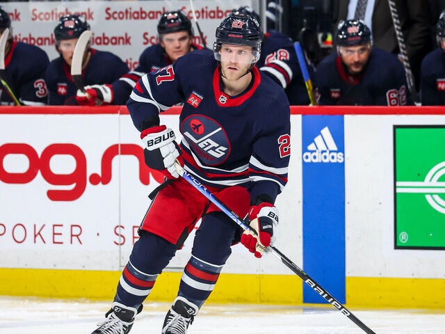 WINNIPEG, CANADA - APRIL 2: Nikolaj Ehlers #27 of the Winnipeg Jets plays the puck during second period action against the New Jersey Devils at the Canada Life Centre on April 2, 2023 in Winnipeg, Manitoba, Canada.