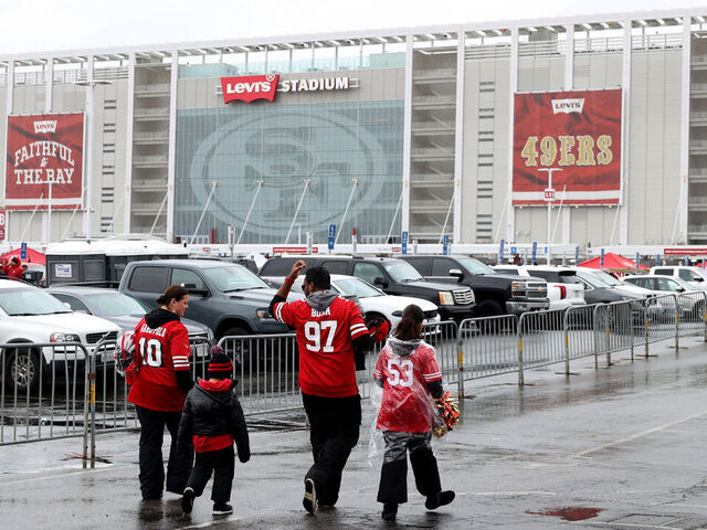 SANTA CLARA, CALIFORNIA - JANUARY 14: San Francisco 49ers fans walk in the parking lot prior to the NFC Wild Card playoff game between the Seattle Seahawks and the San Francisco 49ers at Levi's Stadium on January 14, 2023 in Santa Clara, California.