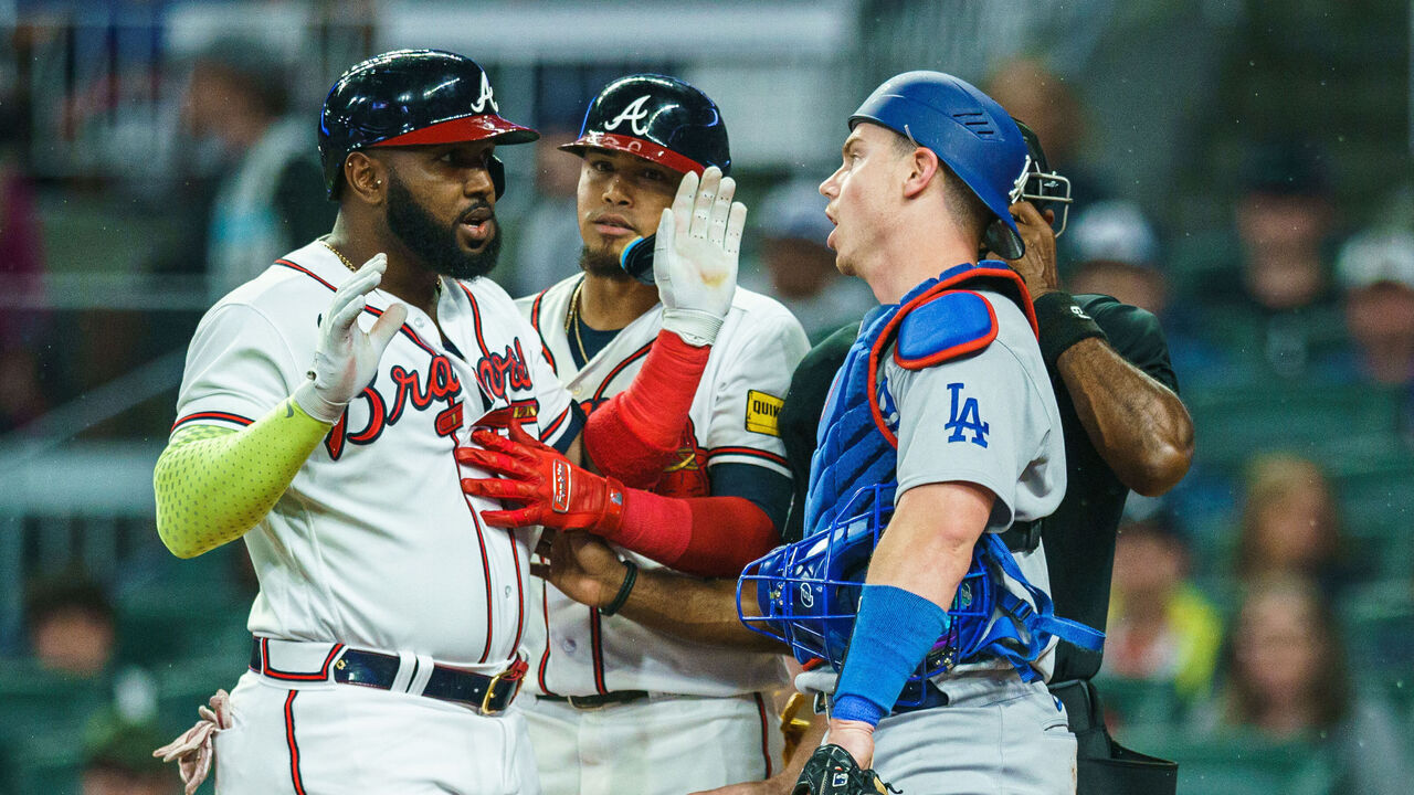 ATLANTA, GA - MAY 22: Marcell Ozuna #20 of the Atlanta Braves and Will Smith #16 of the Los Angeles Dodgers argue during the fourth inning during the game between the Atlanta Braves and the Los Angeles Dodgers at Truist Park on May 22, 2023 in Atlanta, Georgia.