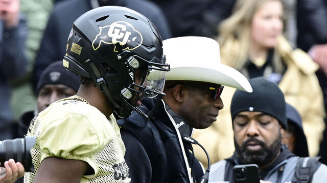 BOULDER, CO - APRIL 22: Colorado Buffaloes QB Shedeur Sanders and his father, head coach Deion Sanders before on the field before the Black and Gold game at Folsom Field April 22, 2023.