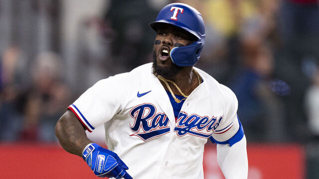 ARLINGTON, TX - APRIL 11: Adolis Garcia #53 of the Texas Rangers reacts to a hit that allows Marcus Semien #2 to score during a game against the Kansas City Royals at Globe Life Field on April 11, 2023 in Arlington, Texas.